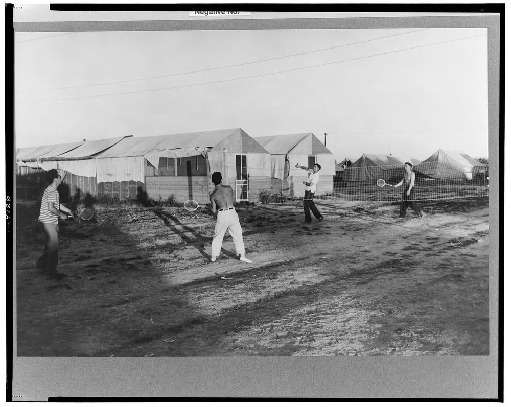 Nyssa, Oregon. FSA (Farm Security Administration) mobile camp. Japanese-Americans play badminton at the camp by Russell Lee
