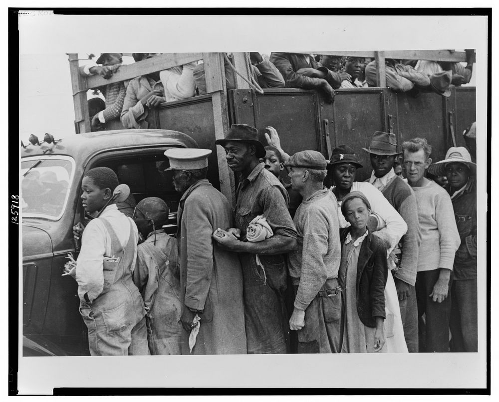 Vegetable workers, migrants, waiting after work to be paid. Near Homestead, Florida. Sourced from the Library of Congress.