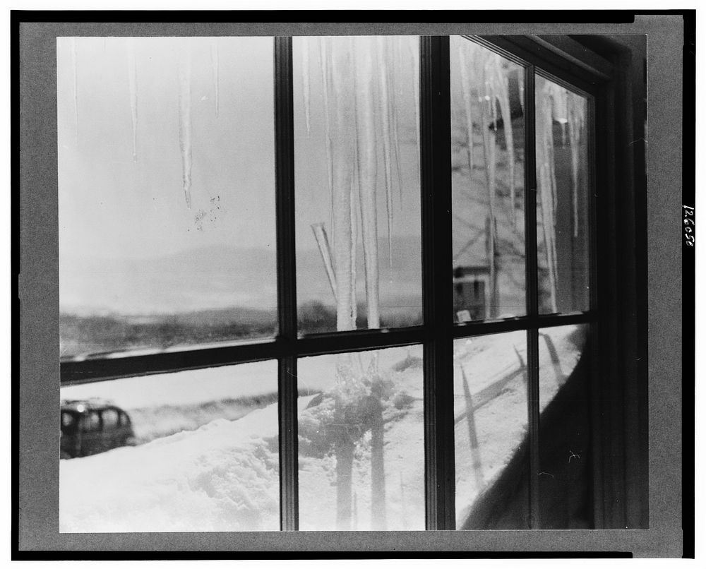 Looking out of ski lodge window early in the morning at foot of Mount Mansfield, Smuggler's Notch, near Stowe, Vermont.…