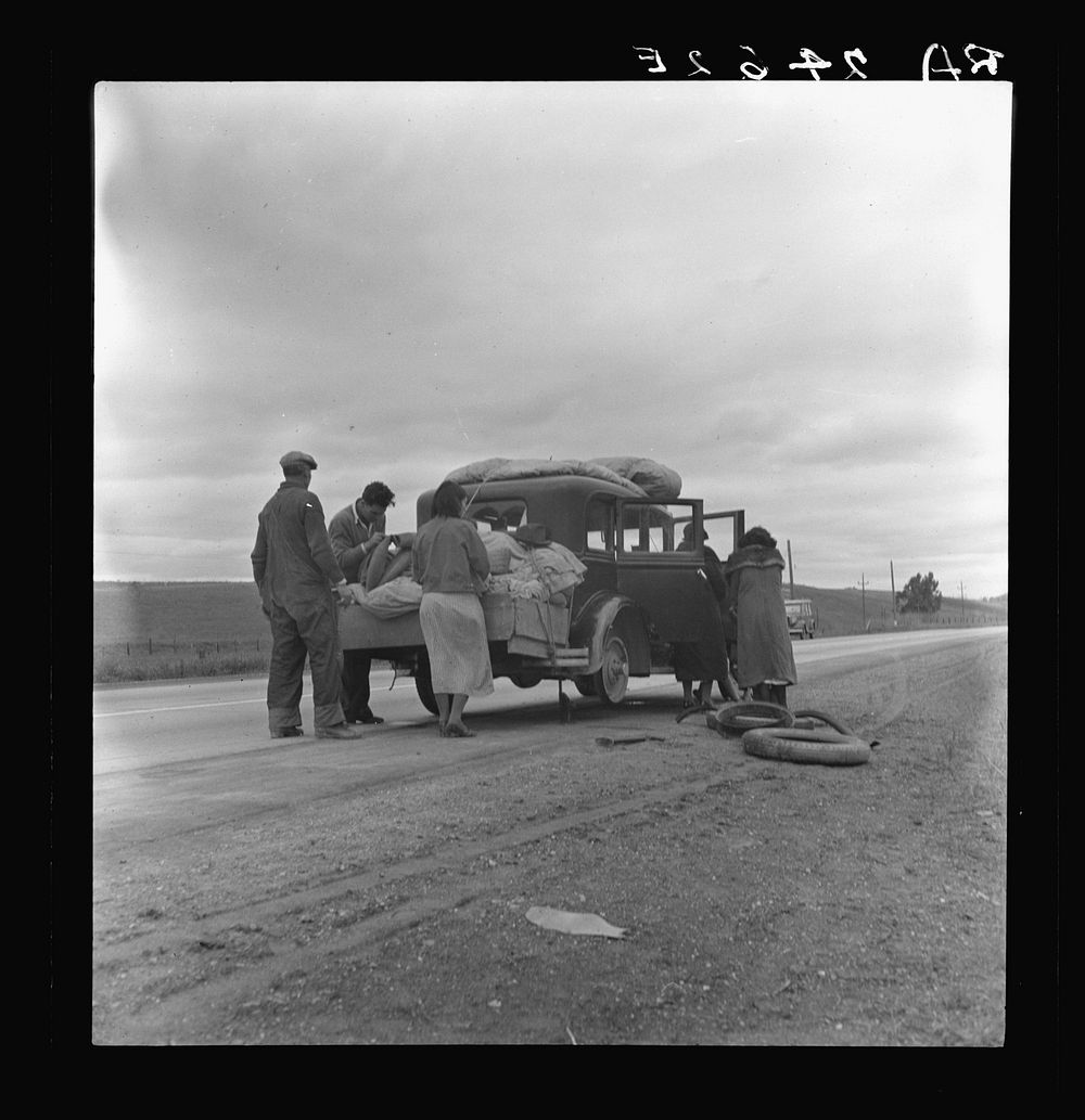 Migrants, family of Mexicans, on road with tire trouble. Looking for work in the peas. California. Sourced from the Library…