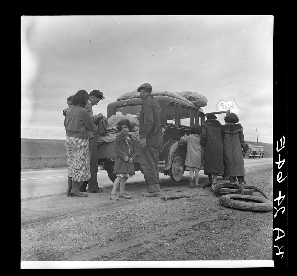 Migrants, family of Mexicans, on road with tire trouble. Looking for work in the peas. California. Sourced from the Library…