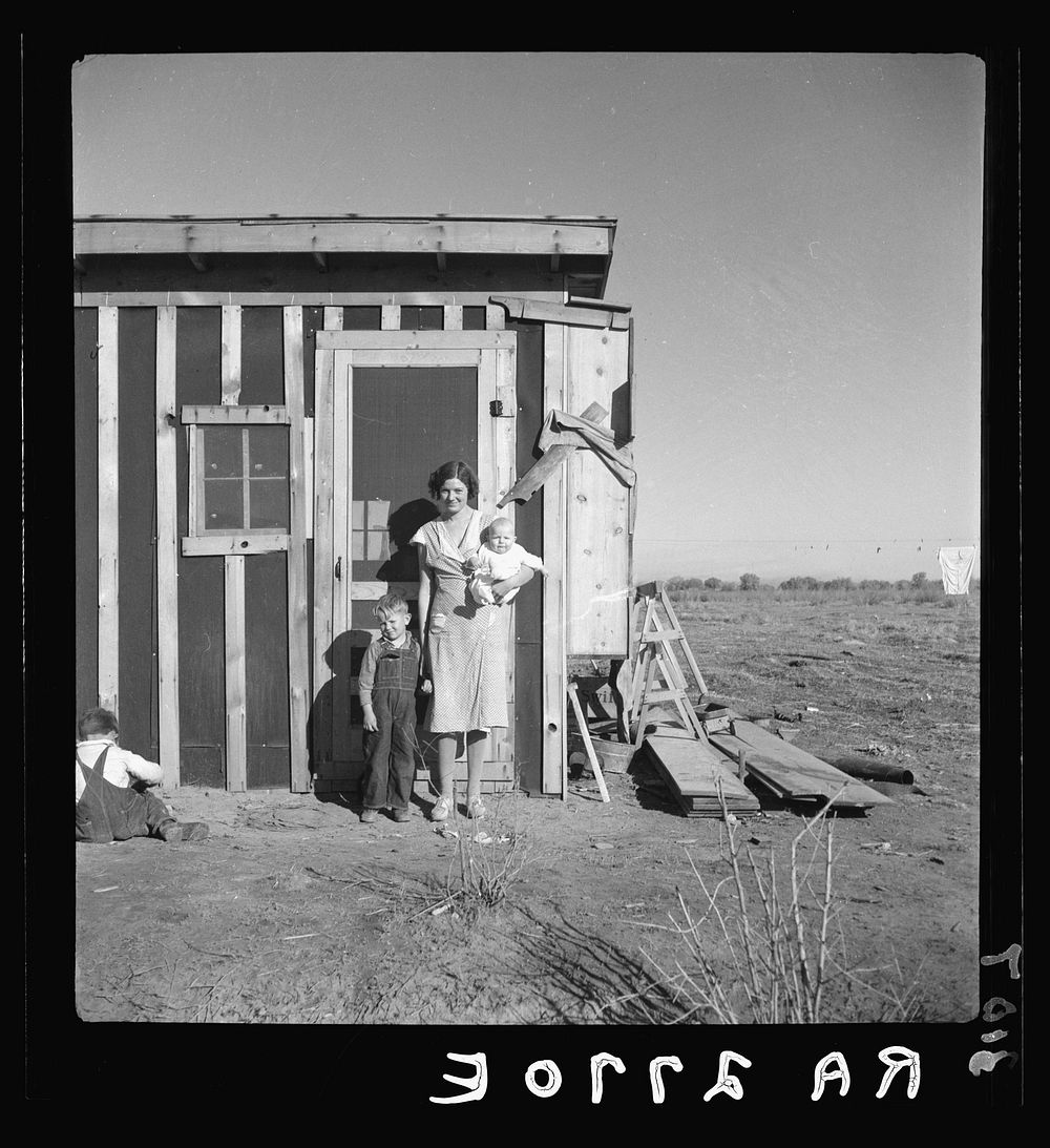 Resettled at Bosque Farms project. Family of four from Taos Junction shows temporary dwelling. Sourced from the Library of…