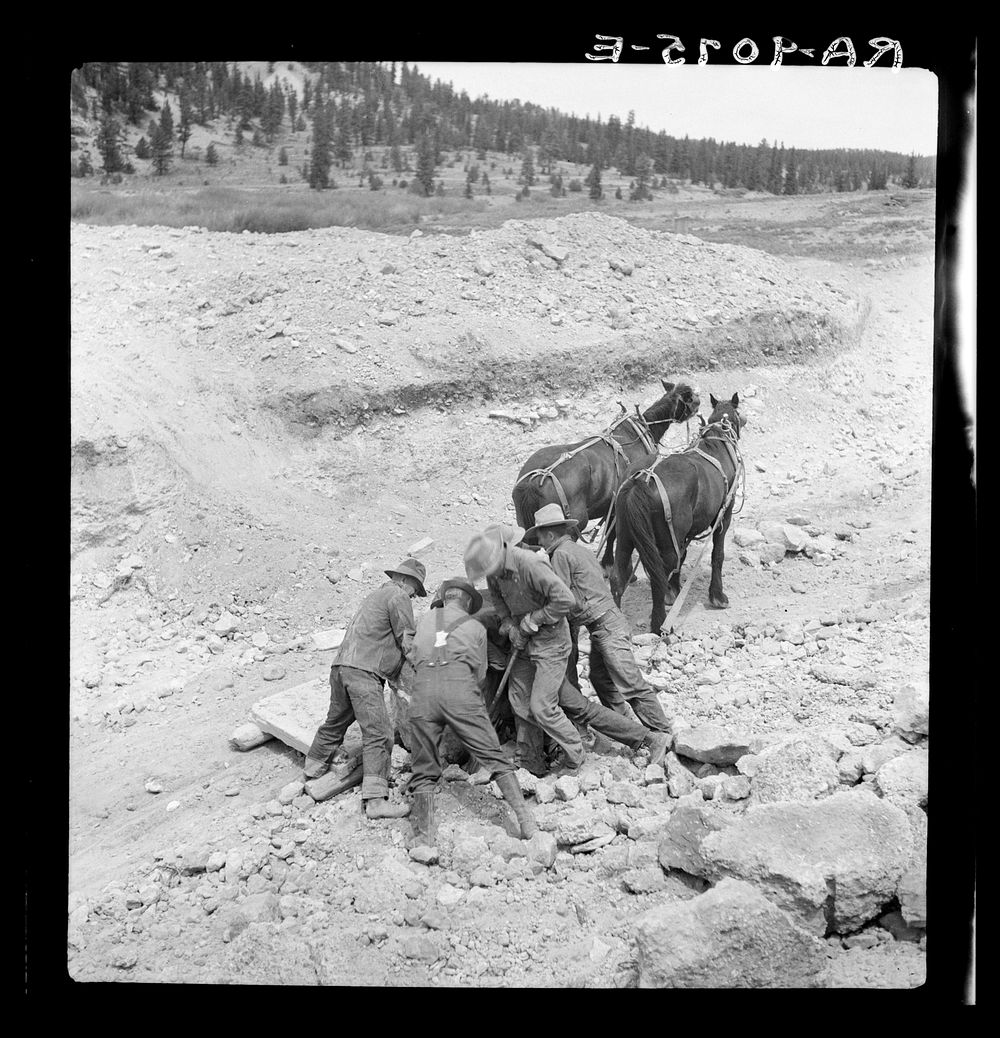 Widtsoe land use adjustment project. Garfield County, Utah. Loading boulder on stone boat, while excavating new spillway of…