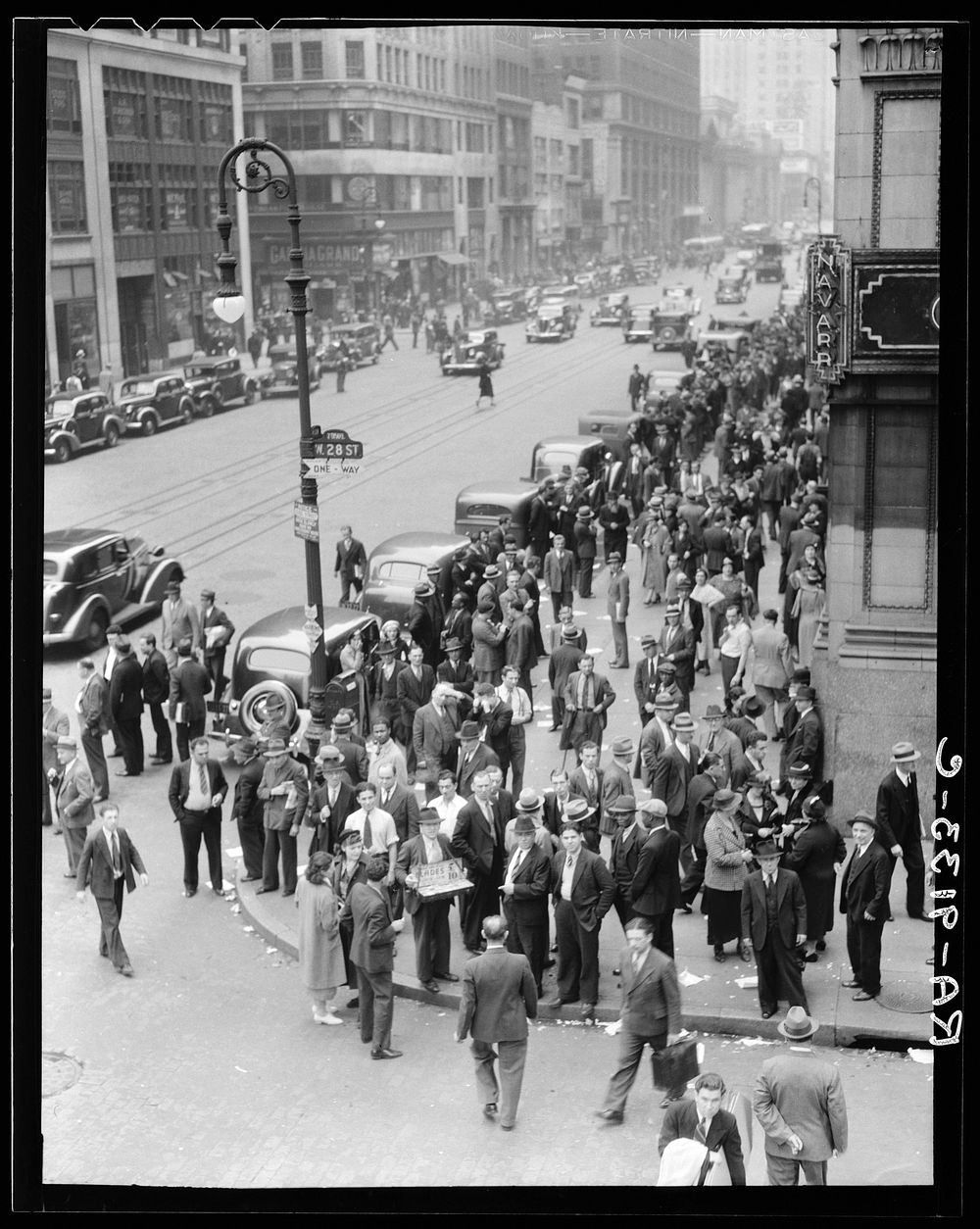 Background for Hightstown project photographs. Seventh Avenue and West 28th Street, New York. Garment workers leave the…