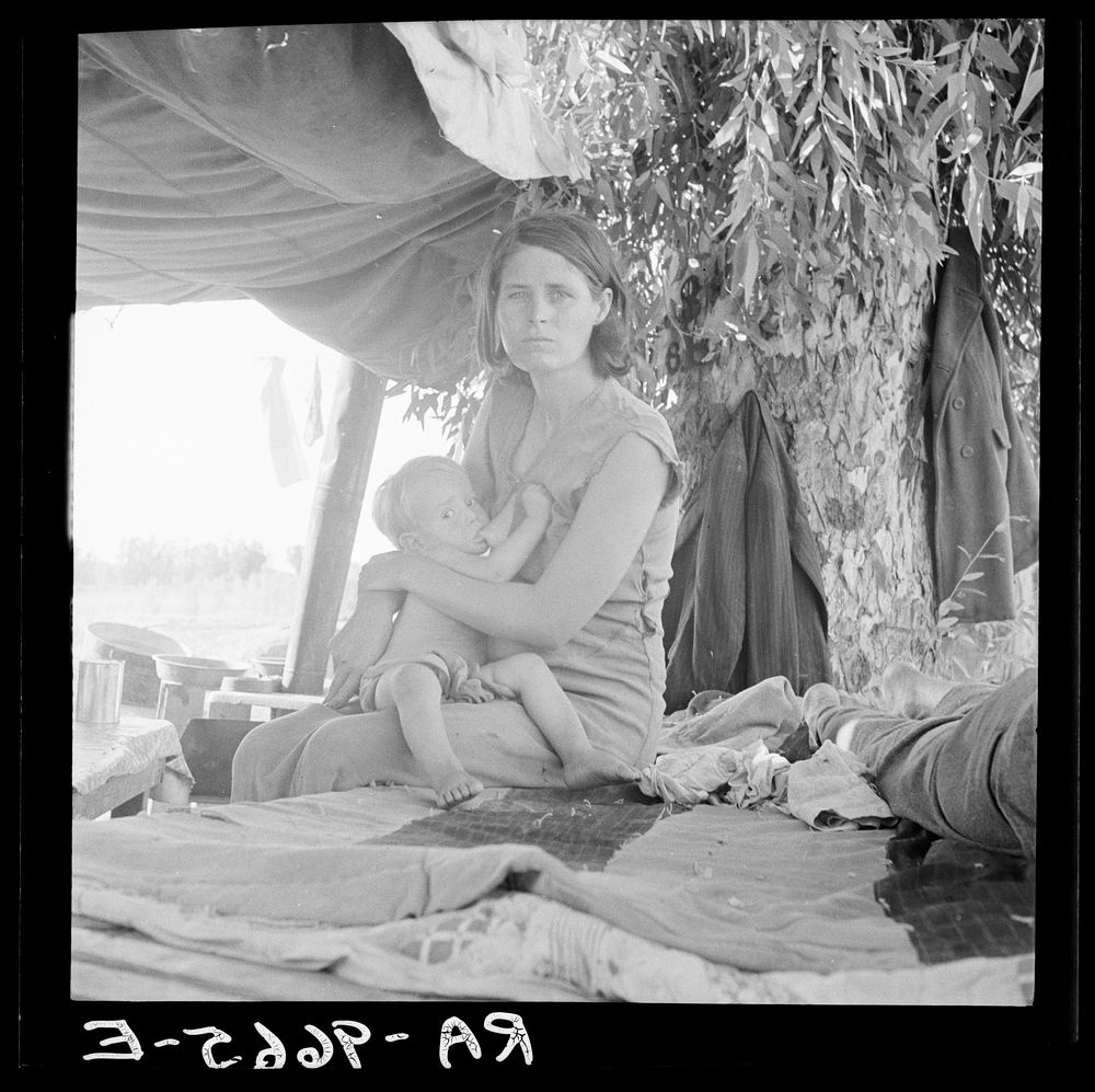 Drought refugees from Oklahoma camping by the roadside. They hope to work in the cotton fields. The official at the border…