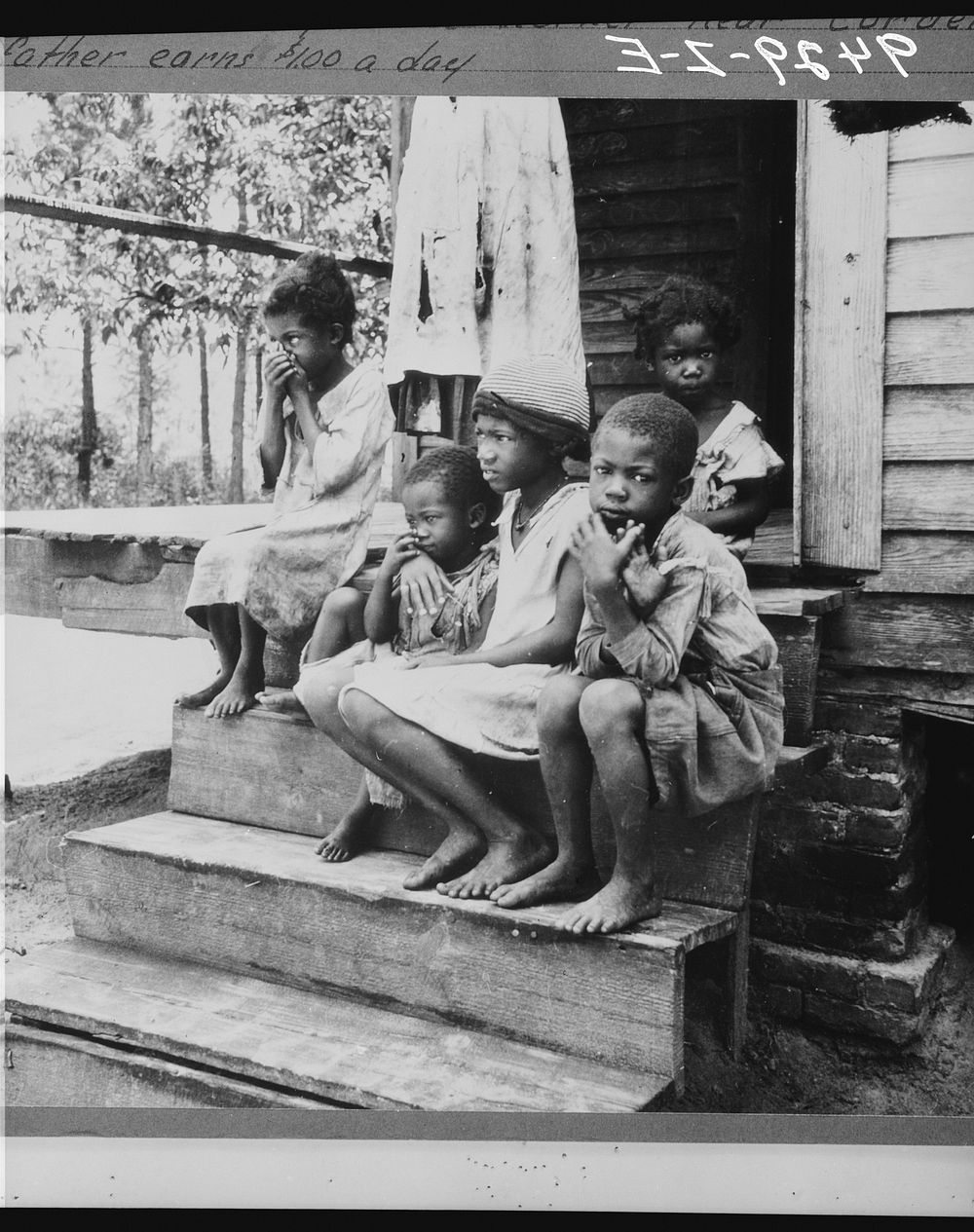 Children of turpentine worker near Cordele, Alabama. The father earns one dollar a day by Dorothea Lange