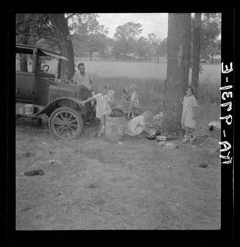 Migrant family from Oklahoma in Texas. A family of six alongside the road. An example of how they fall between the relief…