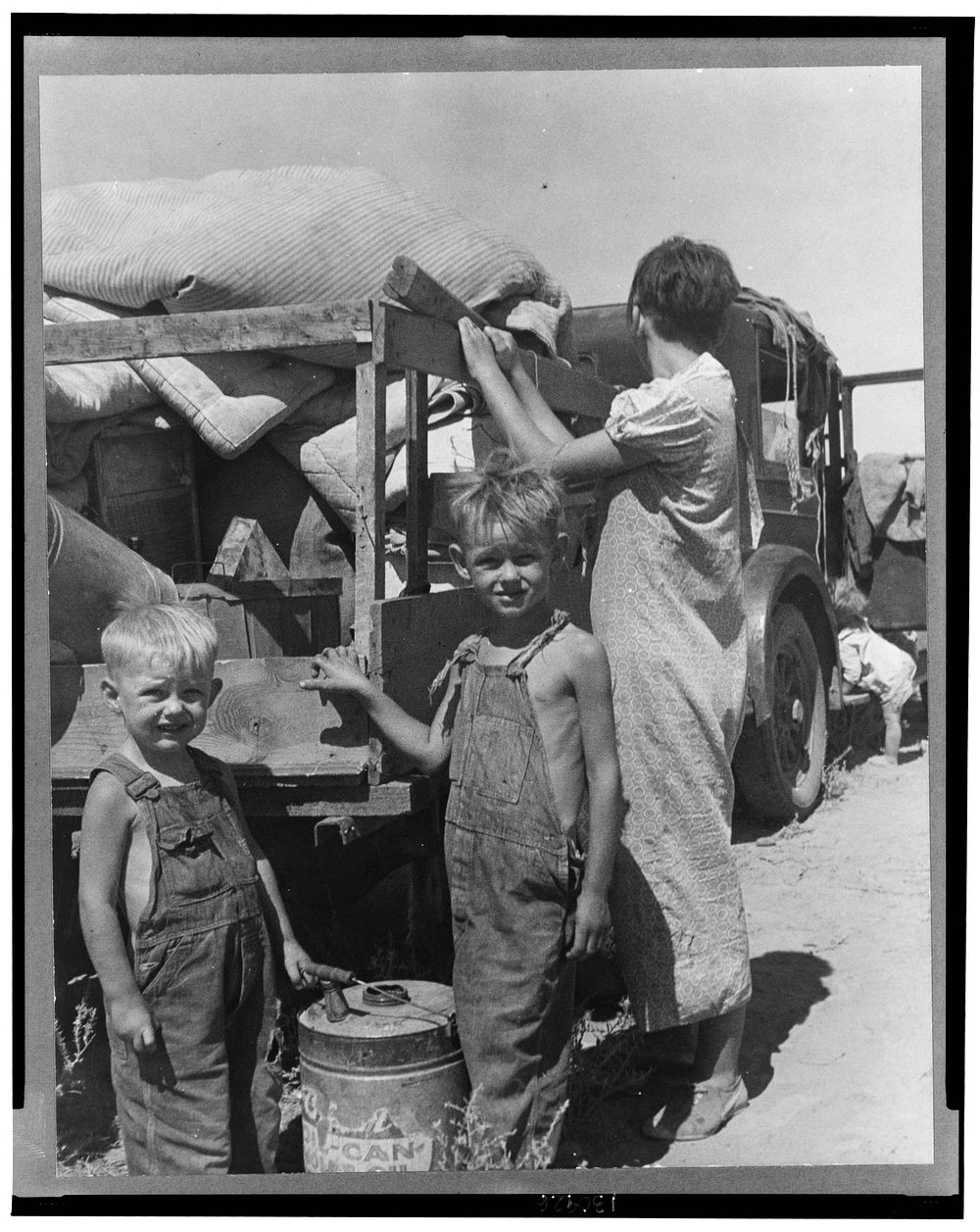 Part of an impoverished family of nine on a New Mexico highway. Depression refugees from Iowa. Left Iowa in 1932 because of…