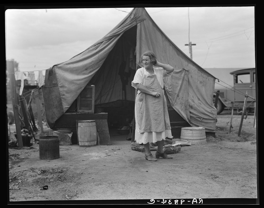 Mother of family of migrant fruit workers encamped on the outskirts of Porterville, California, waiting for work in the…