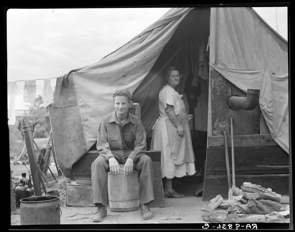 Part of migrant family of five, encamped near Porterville, California, while waiting for work in the orange groves. Sourced…