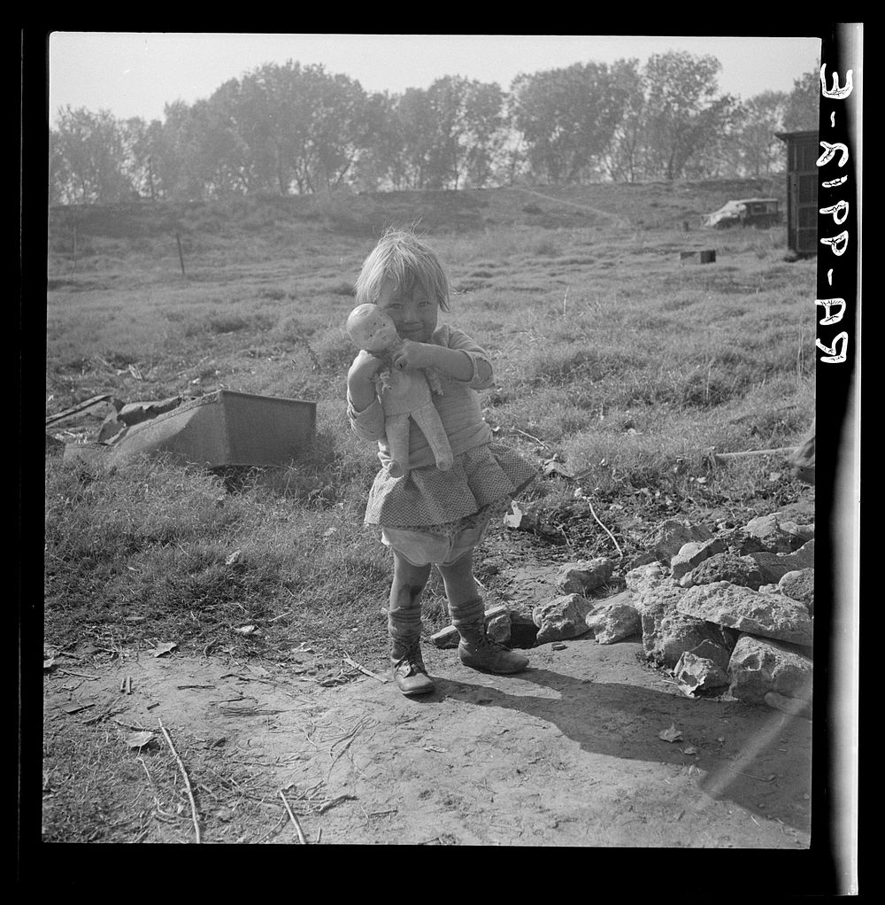 Daughter of a migrant fruit worker. American River camp outside of Sacramento, California by Dorothea Lange