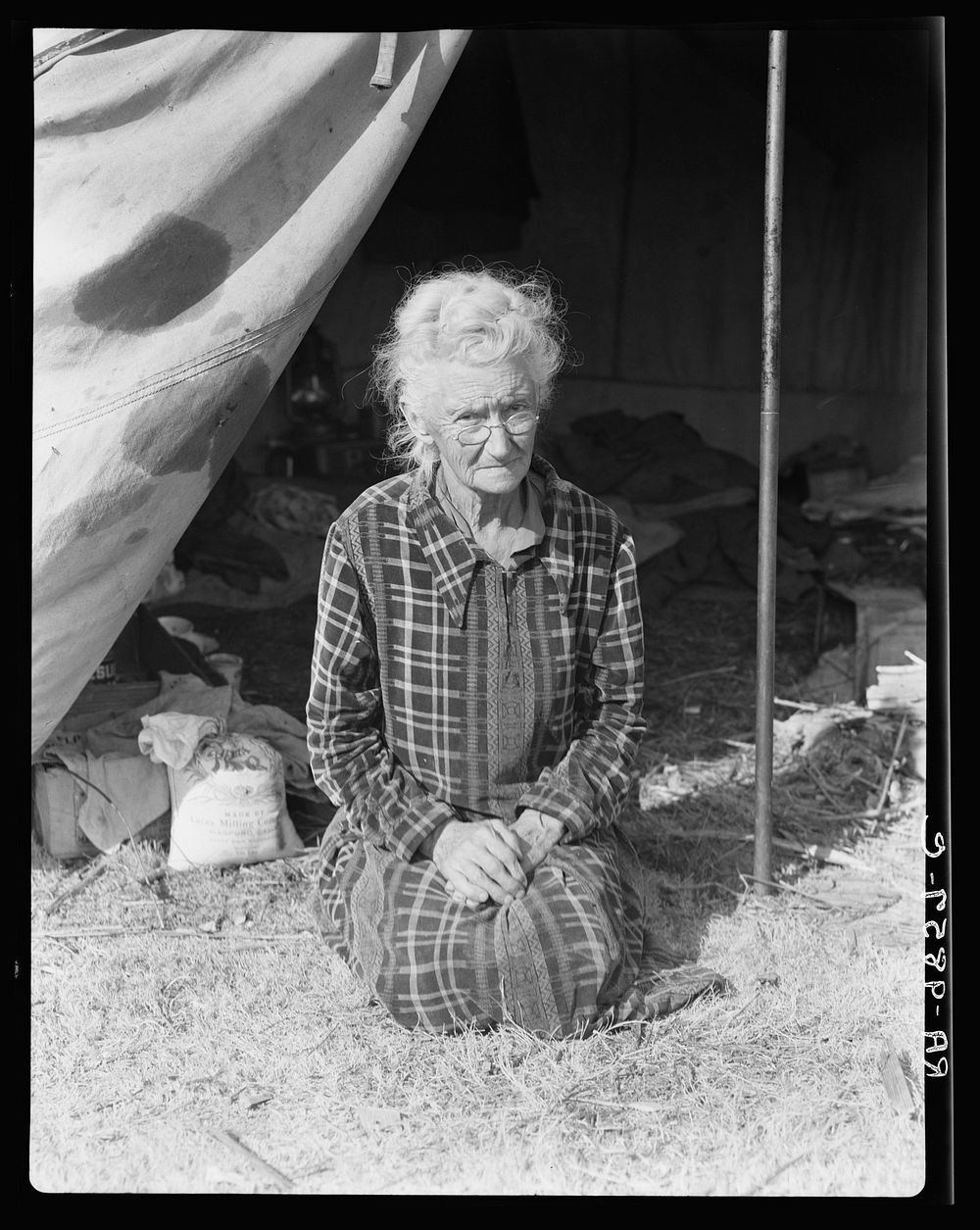 Grandmother of twenty-two children, from a farm in Oklahoma; eighty years old. Now living in camp on the outskirts of…