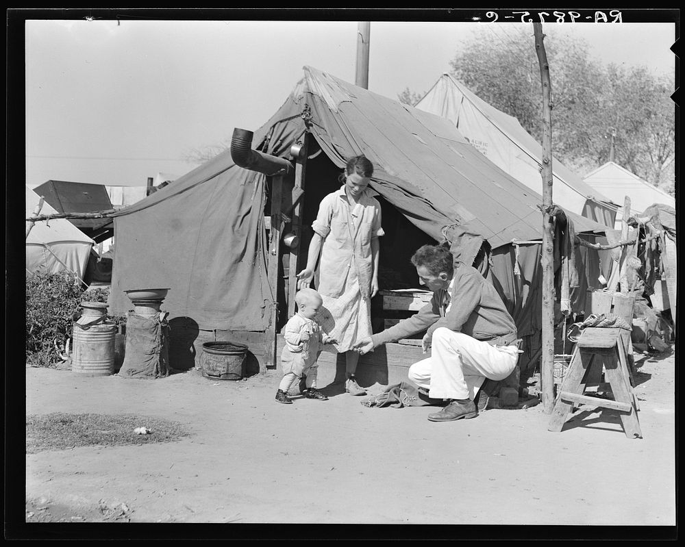 Tom Collins, manager of Kern migrant camp, with drought refugee family. California. Sourced from the Library of Congress.