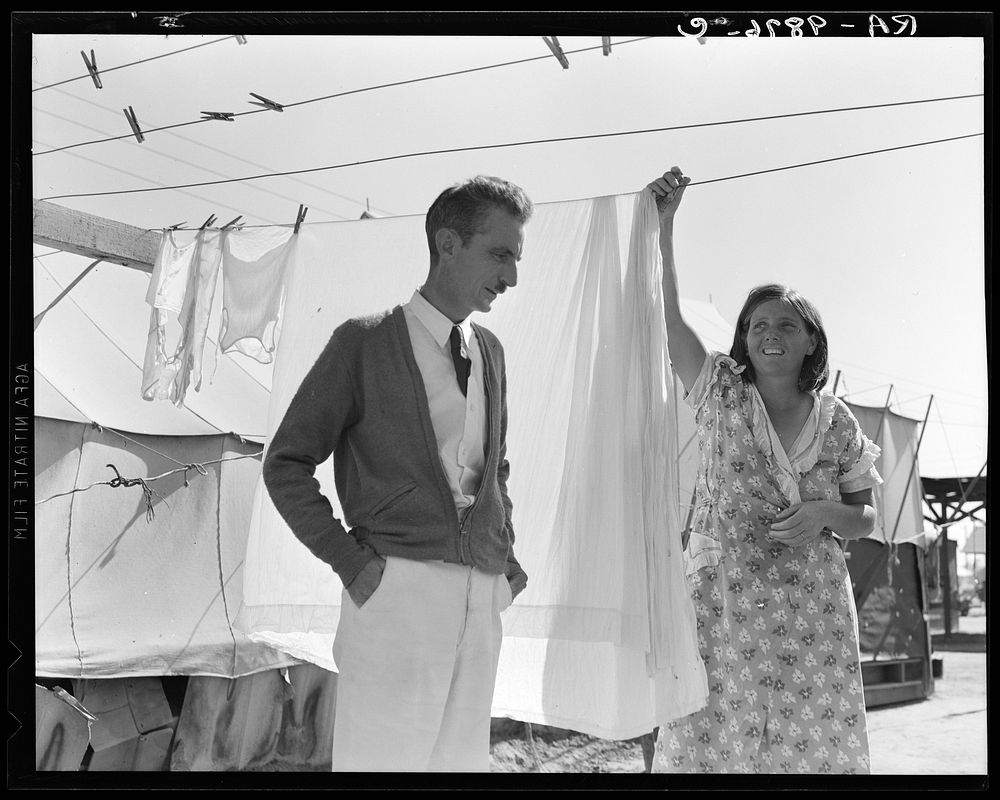 Tom Collins, manager of Kern migrant camp, talking with one of the members. California. Sourced from the Library of Congress.