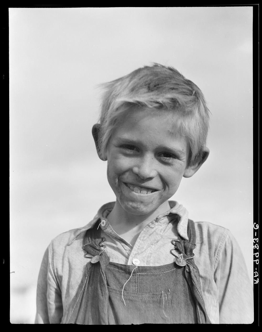 Son of cotton picker living in squatters' camp near Farmersville, California by Dorothea Lange
