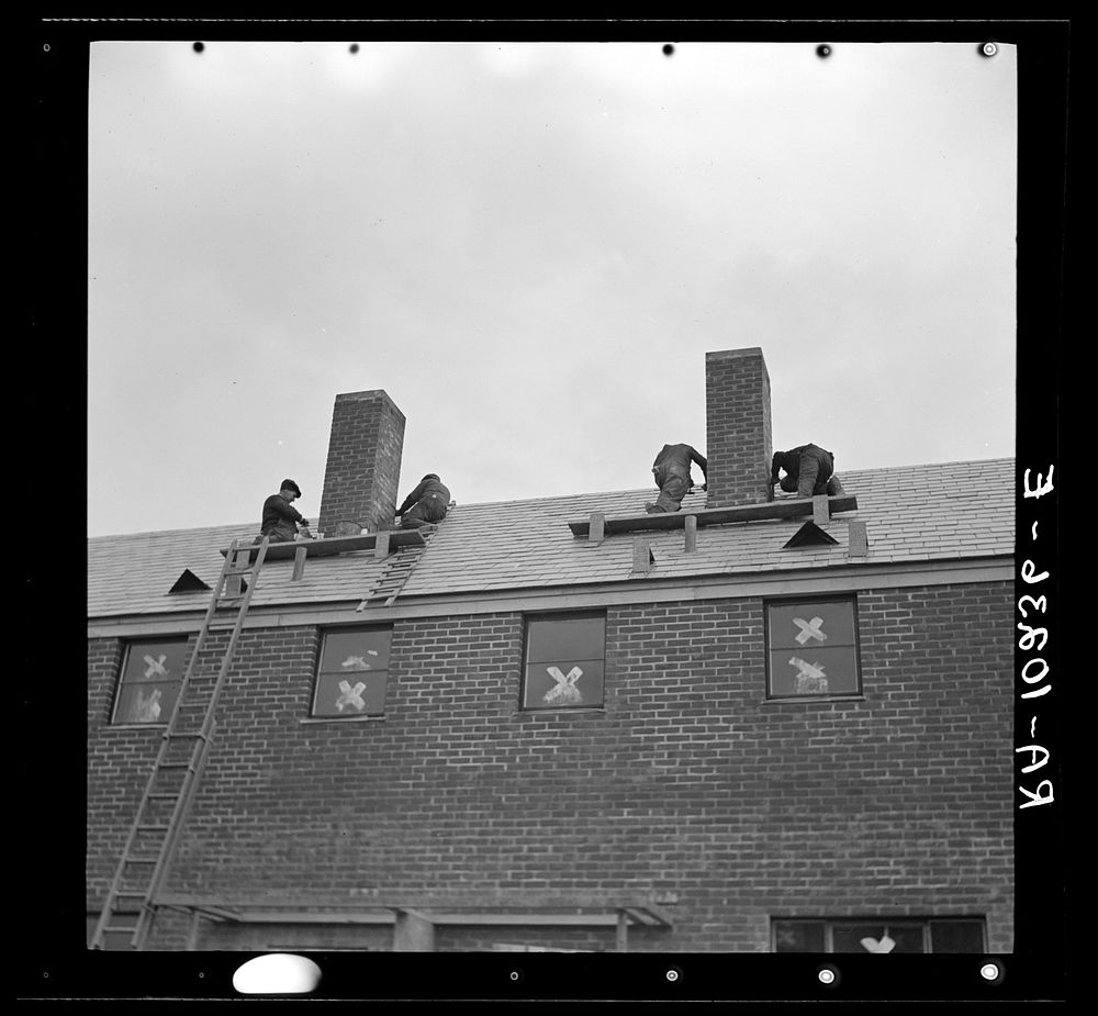 Men working on flashing of chimney. Greenhills, Ohio by Russell Lee