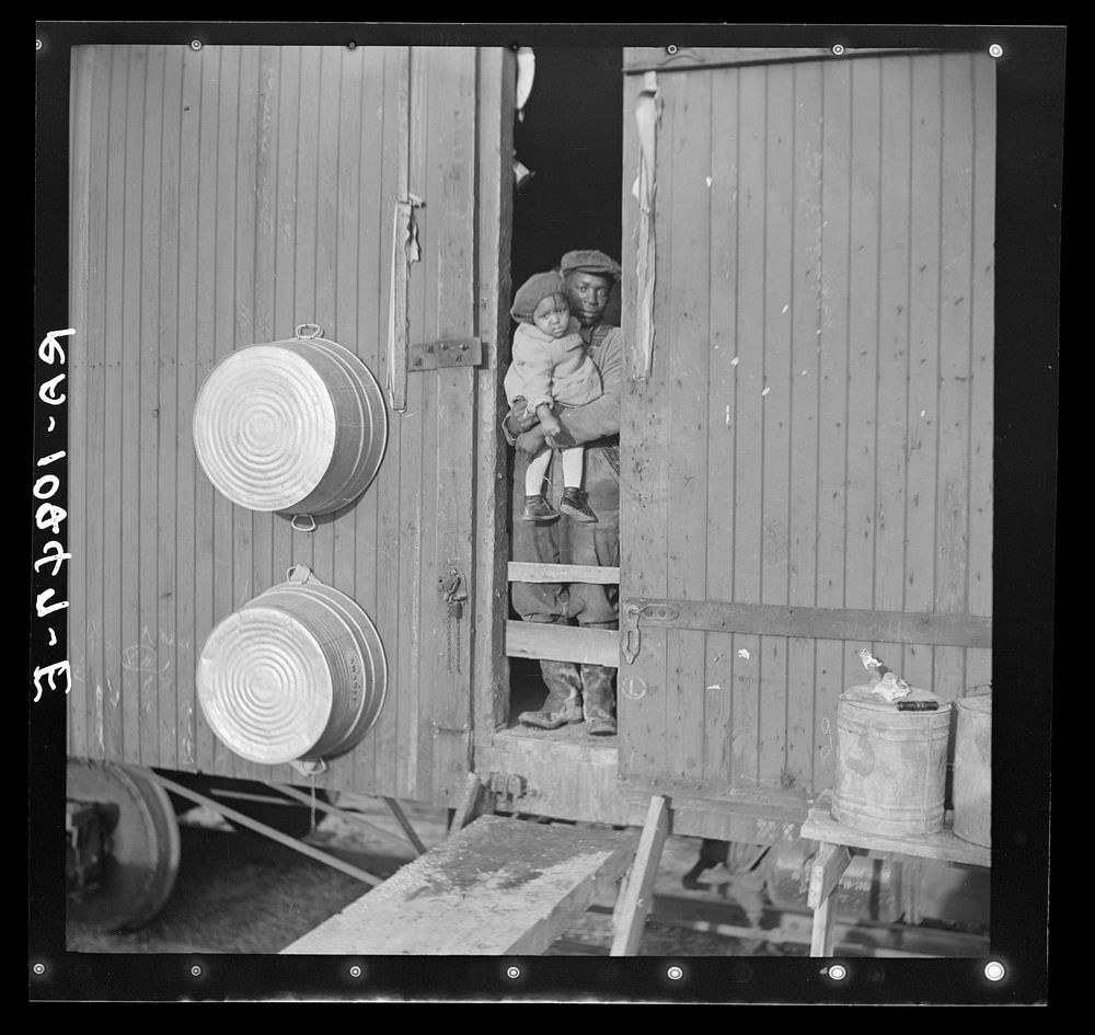 Colored flood refugees at the door of their boxcar home near Cache, Illinois by Russell Lee