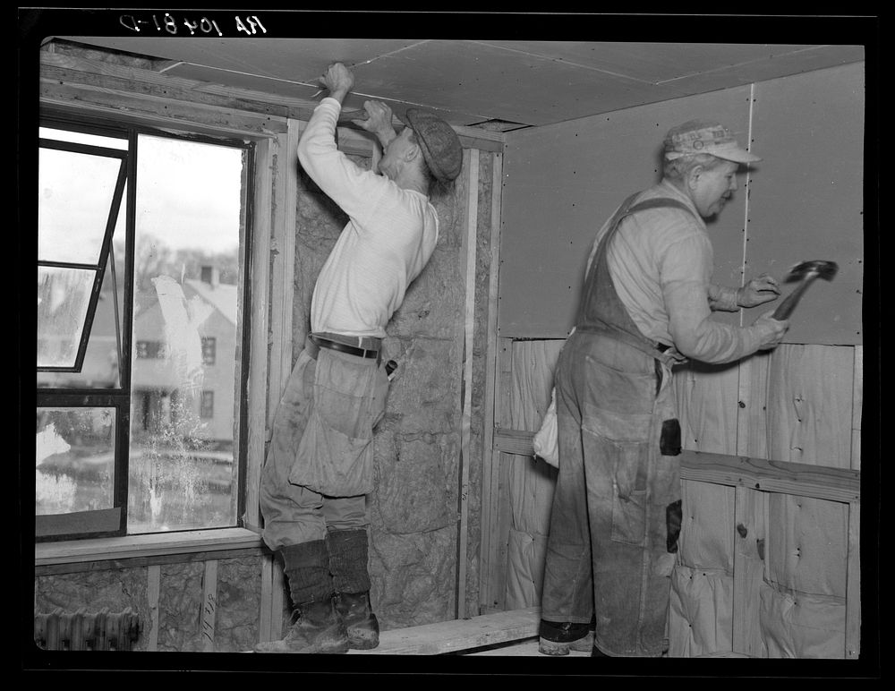 Installing wallboard in a house at the Greenhills project, Ohio. Note sound proofing and insulation by Russell Lee
