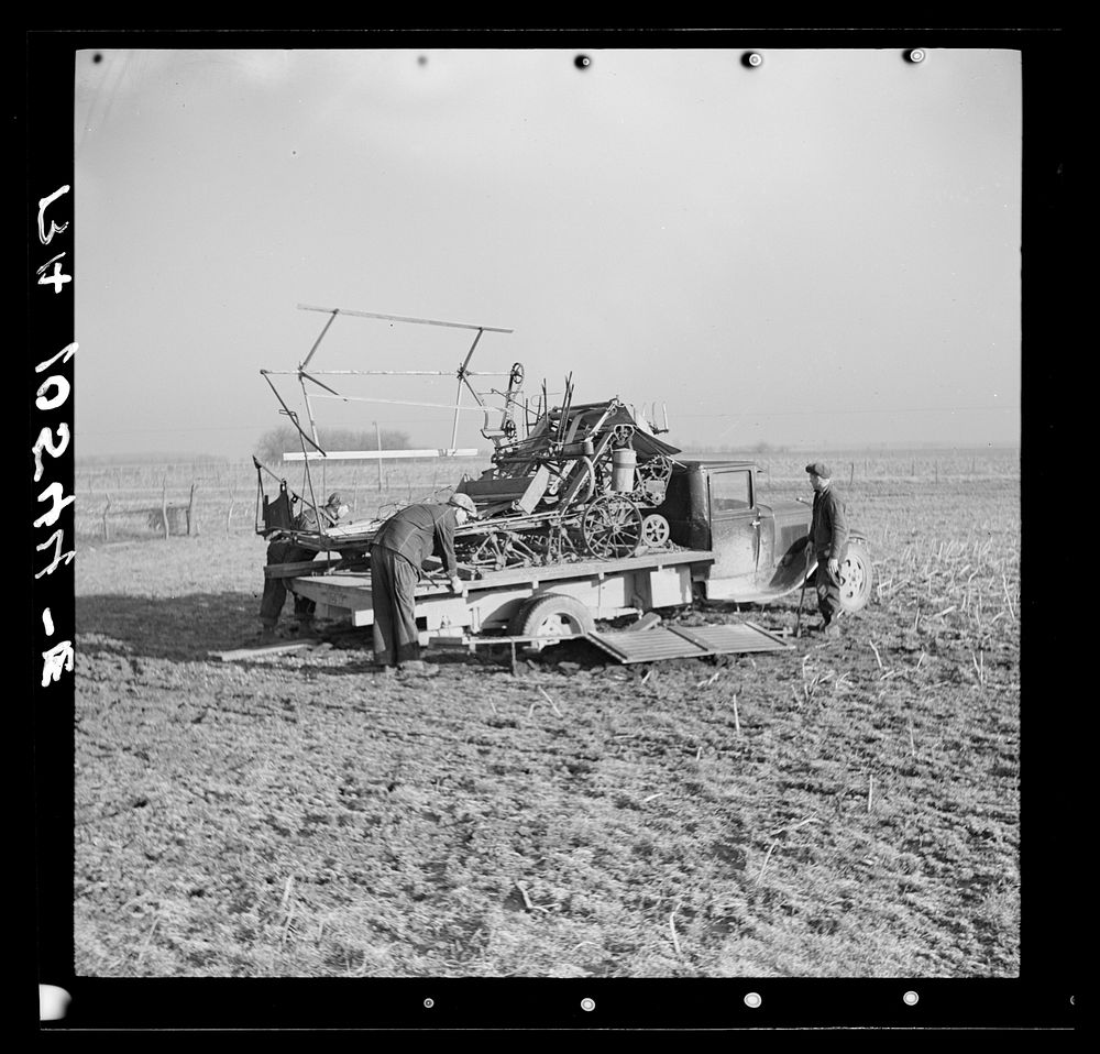 Binder loaded on a truck, preparatory to moving it. The rear wheels of the truck were lowered by digging pits to facilitate…