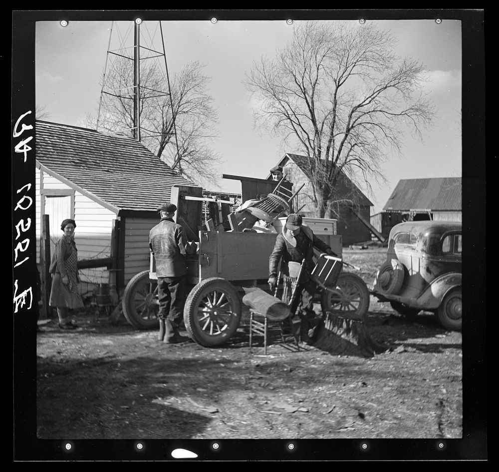 Charles Miller, for twelve years a hired farm hand, moving his household goods onto the farm he has now rented to work for…