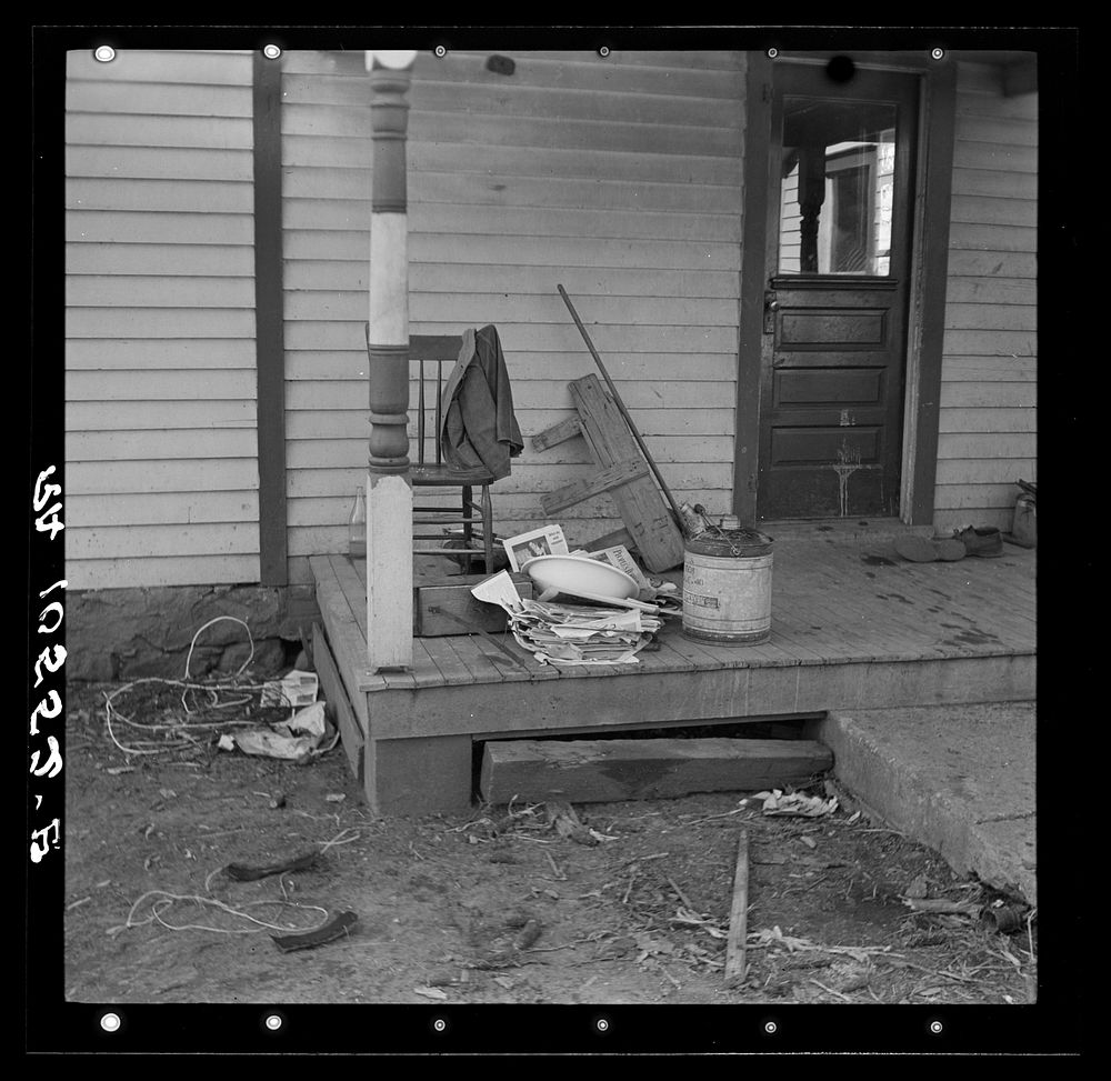 Backporch of Charles Miller's farmhouse during moving operations. Miller, for twelve years a hired farmhand, has now rented…