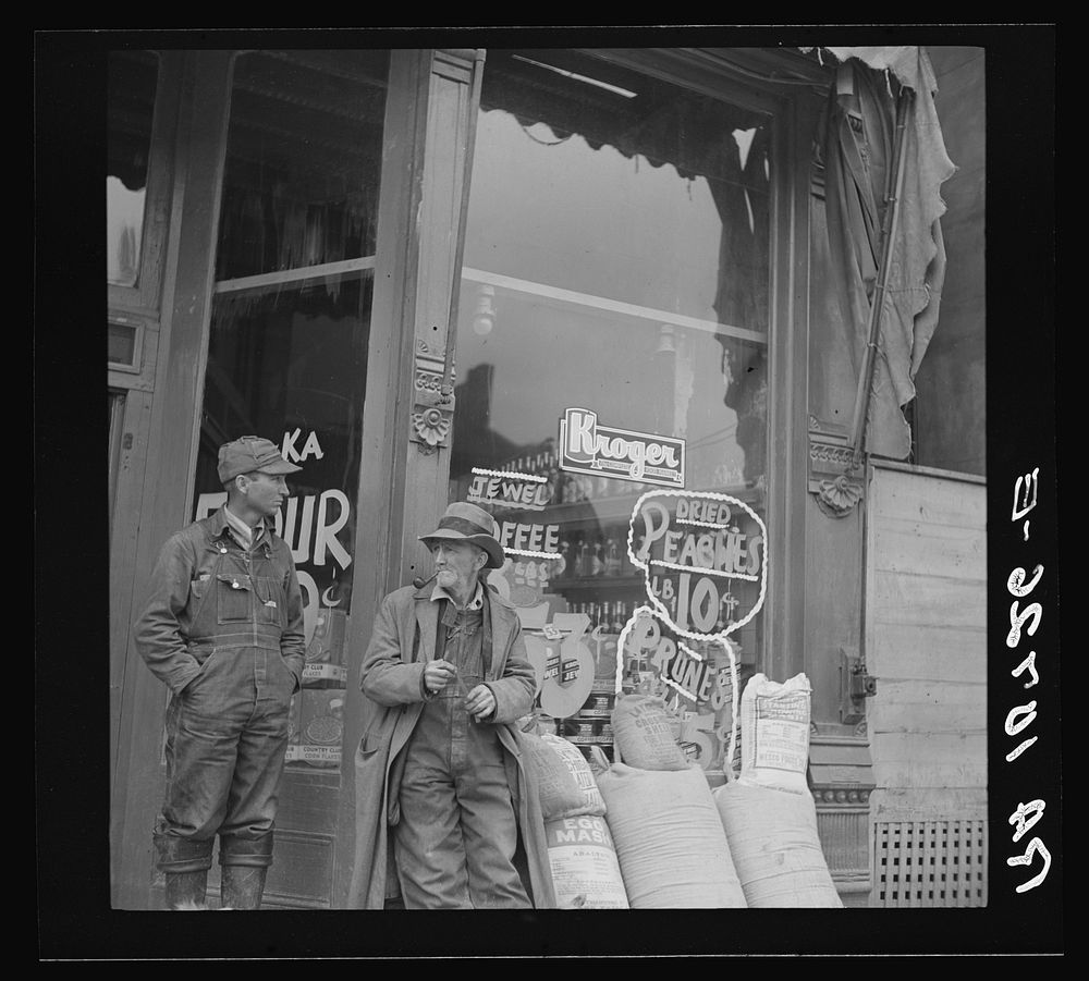 Men in front of grocery store. Shawneetown, Illinois by Russell Lee