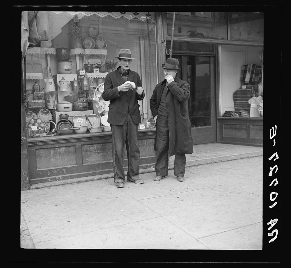 Men in front of grocery and department store. Shawneetown, Illinois by Russell Lee