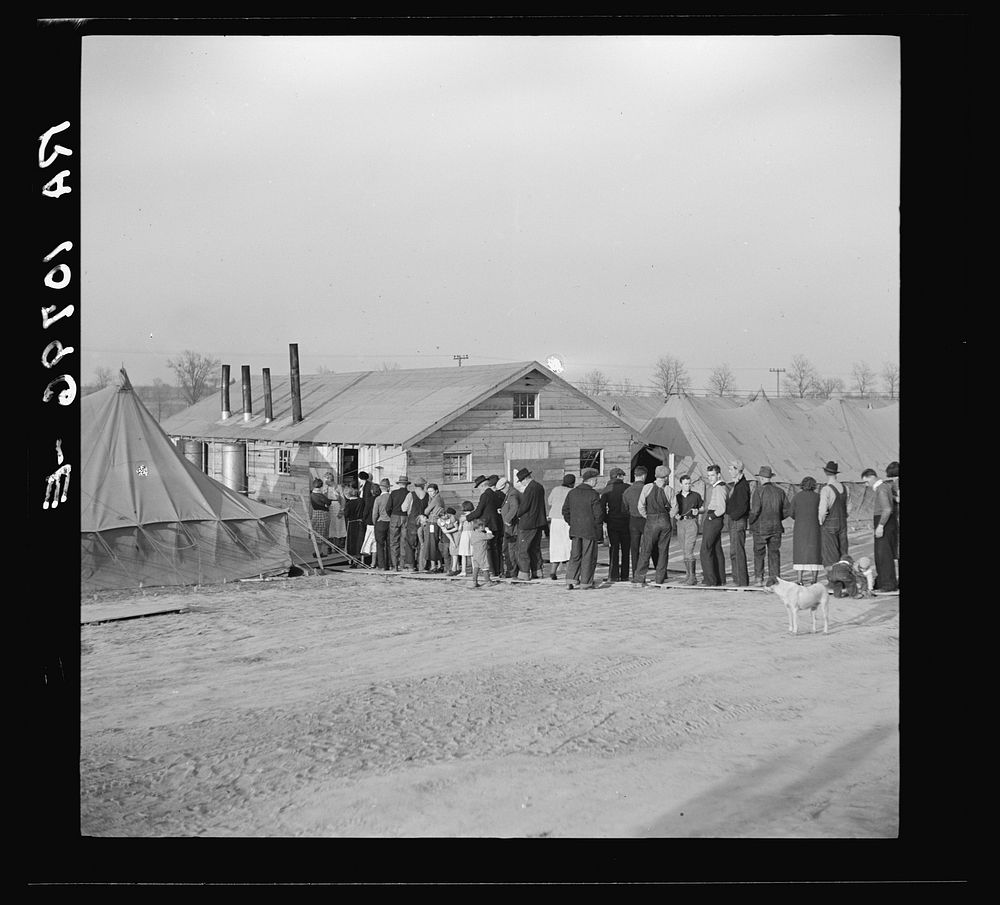 Men, women and children waiting in line to be fed. Tent City, Shawneetown, Illinois by Russell Lee