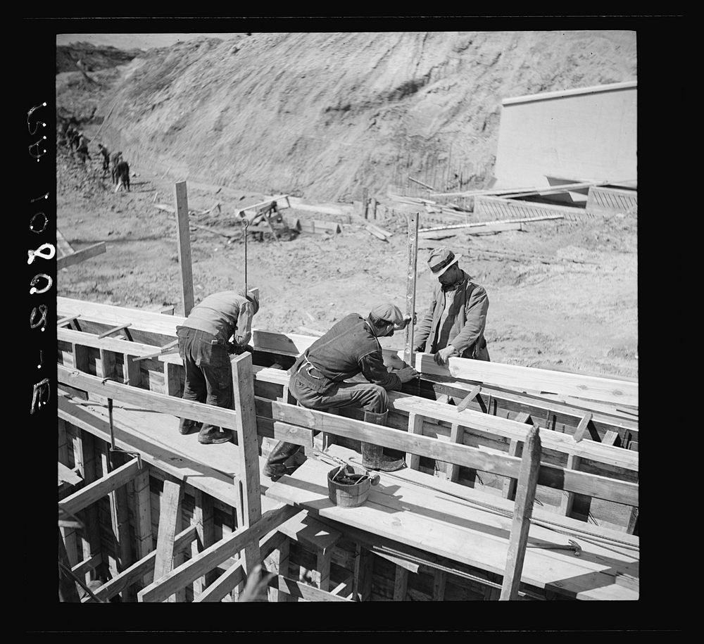 Men working on forms for concrete wall for spillway. Martin Company development project. Indiana by Russell Lee