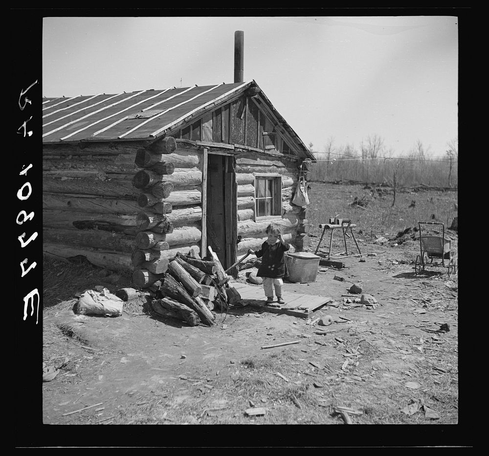 One of the Bodray children in front of the family home near Tipler, Wisconsin by Russell Lee