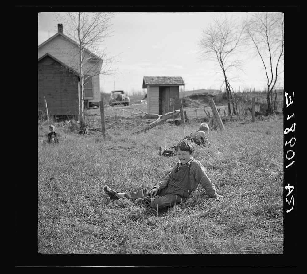 Children resting during recess at a rural school near Tipler, Wisconsin by Russell Lee