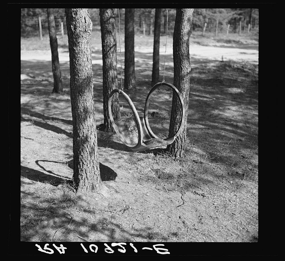 Swing made of an old rubber tire. Gibbs City, Michigan by Russell Lee