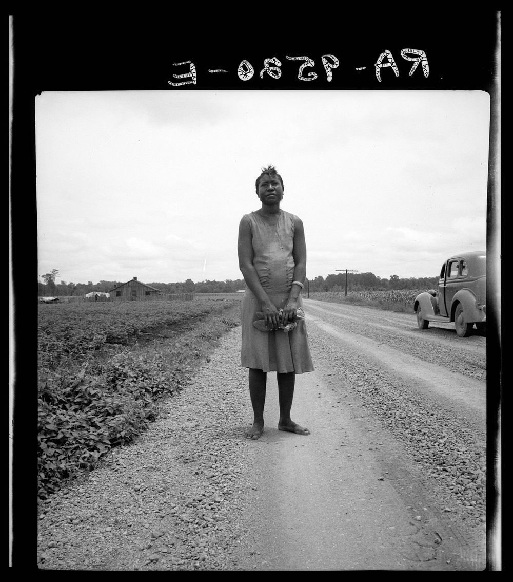 [Untitled photo, possibly related to:  woman carrying her shoes home from church. Mississippi Delta] by Dorothea Lange