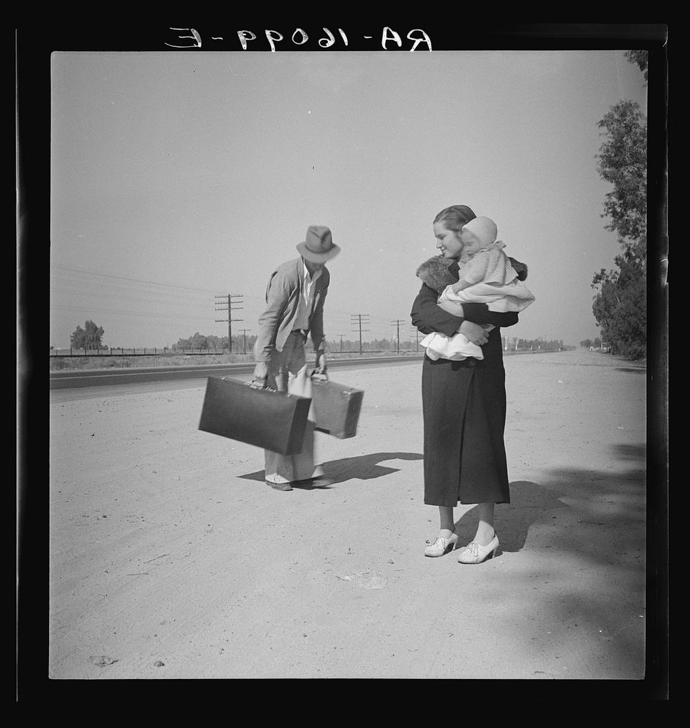 Young family, penniless, hitchhiking on U.S. Highway 99 in California. The father, twenty-four, and the mother, seventeen…