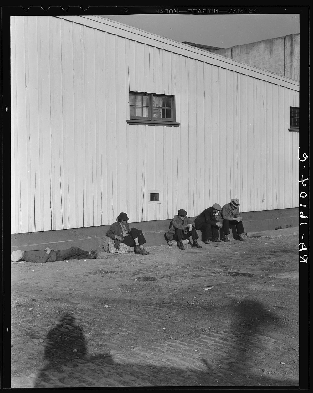 On the sun side of the shed. Transient men, San Francisco, California. Sourced from the Library of Congress.