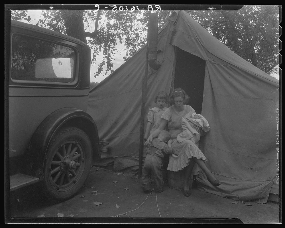Mother and three children in a California squatter camp by Dorothea Lange