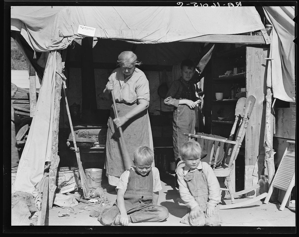 Aged woman with three of her twenty-two grandchildren, Kern county migrant camp, California. Sourced from the Library of…