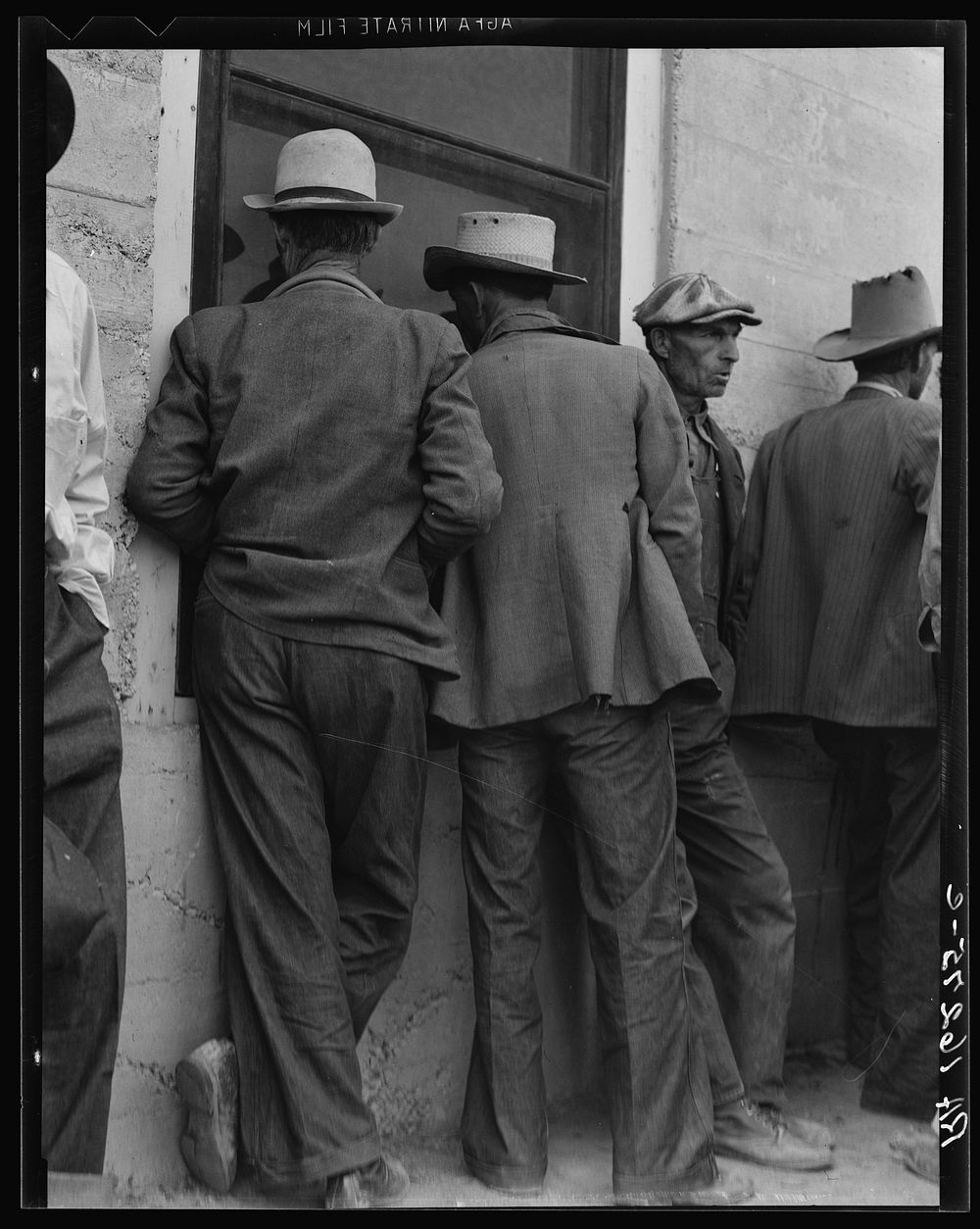 Waiting for the relief checks at Calipatria, California by Dorothea Lange