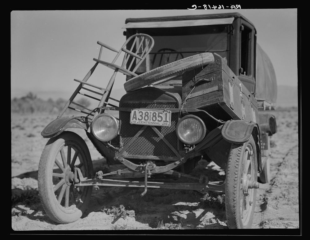 Car of drought refugee on edge of carrot field in the Coachella Valley. California by Dorothea Lange