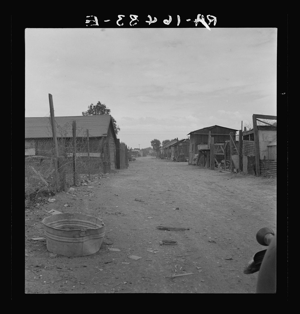 Slums of East El Centro, California. Typical of housing and sanitary conditions of Mexican field workers of the Imperial…