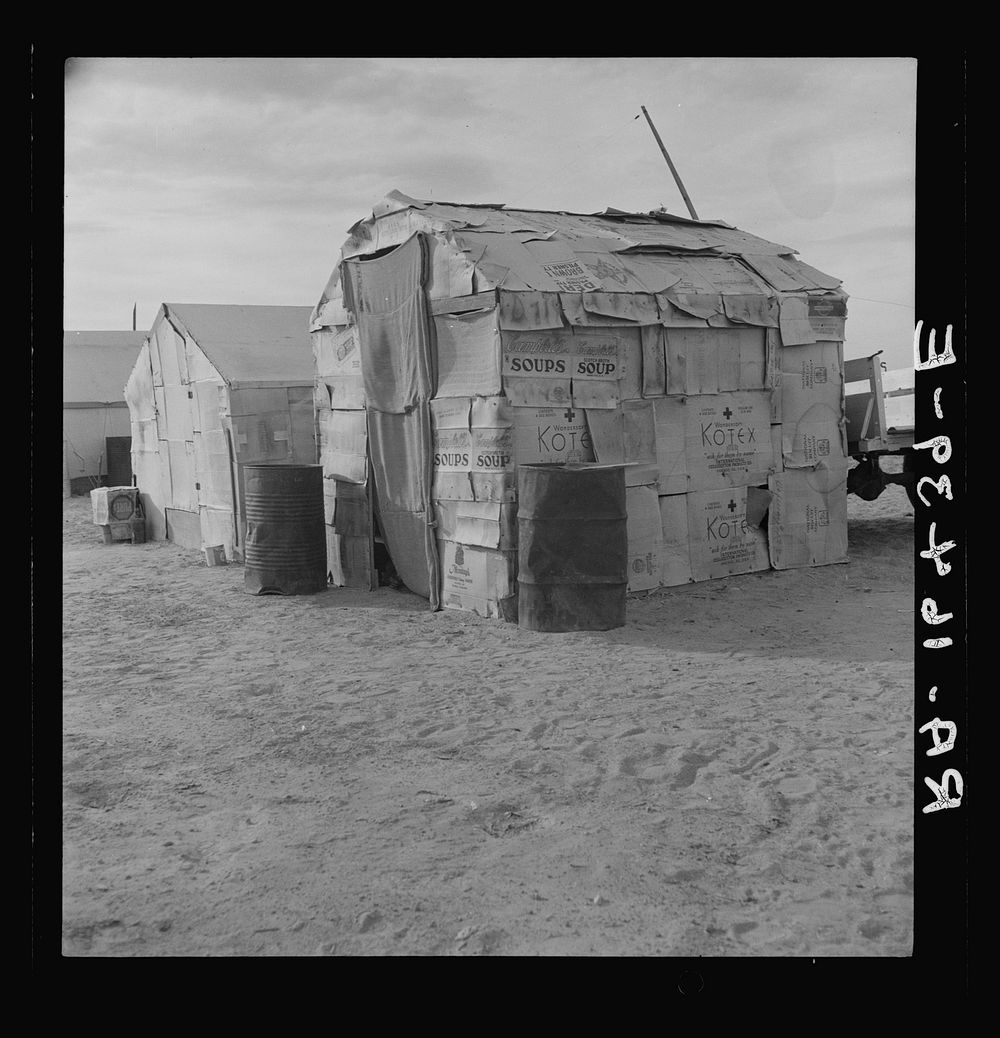 Migratory field worker's home on the edge of a pea field. The family lived here through the winter. Imperial Valley…