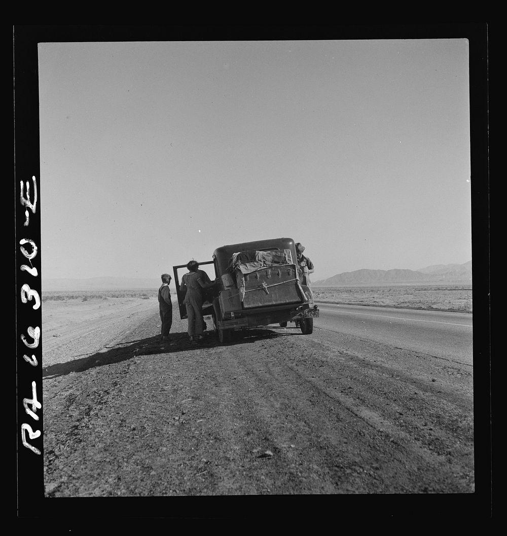 Oklahoma sharecropper entering California stalled on the desert with his wife and four children. Sourced from the Library of…