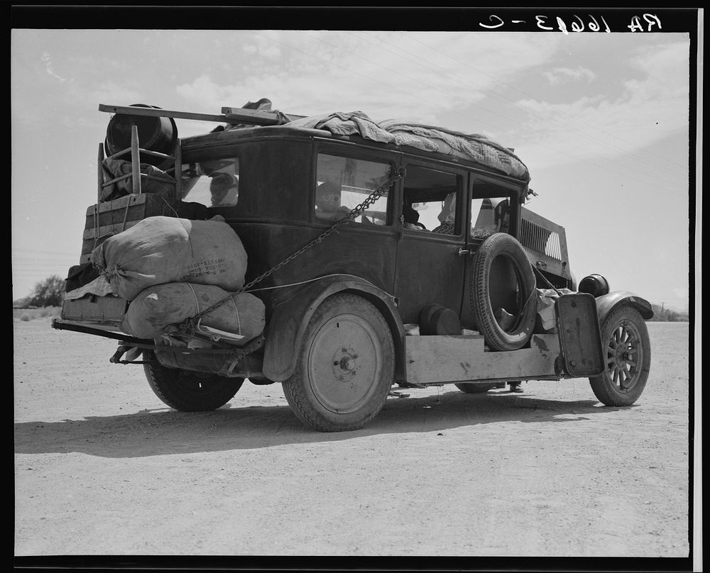 Family of nine from Fort Smith, Arkansas, trying to repair their car on road between Phoenix and Yuma, Arizona. On their way…