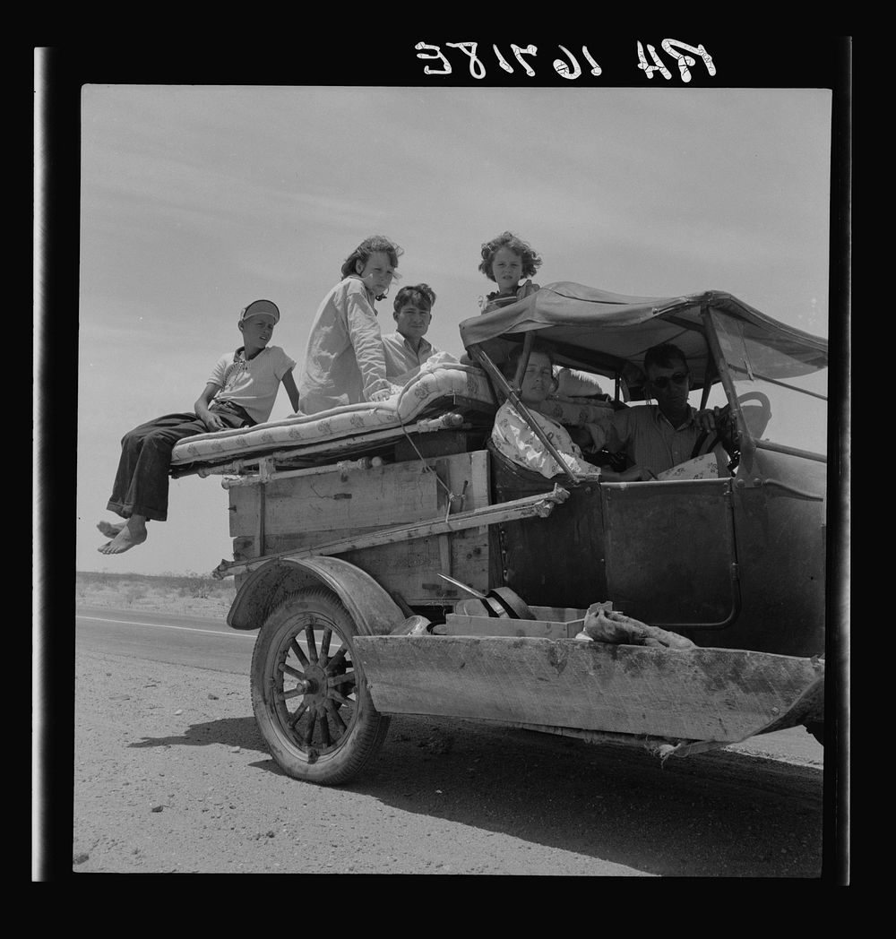 Migratory family traveling across the desert in search of work in the cotton at Roswell, New Mexico. U.S. Route 70, Arizona.…
