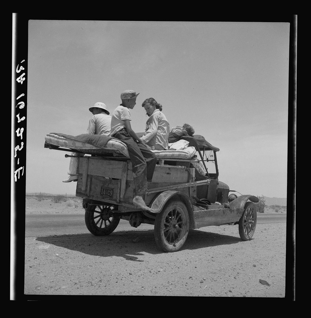 Migratory family traveling across the desert in search of work in the cotton at Roswell, New Mexico. U.S. Route 70, Arizona…