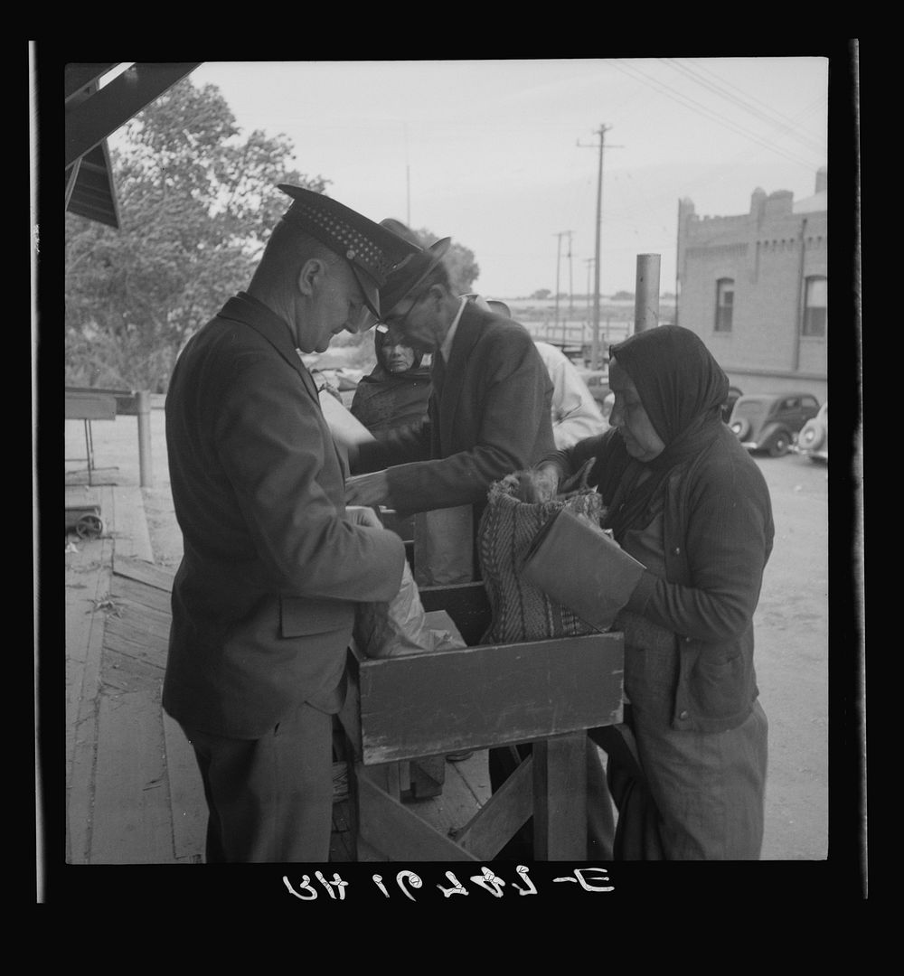 Plant quarantine inspectors examining goods bought in Juarez, Mexico before entering El Paso, Texas. Sourced from the…