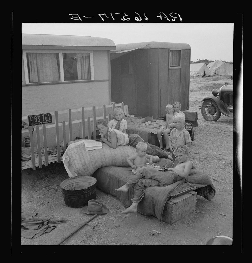 Children from Chickasaw, Oklahoma, in a potato pickers' camp near Shafter, California by Dorothea Lange