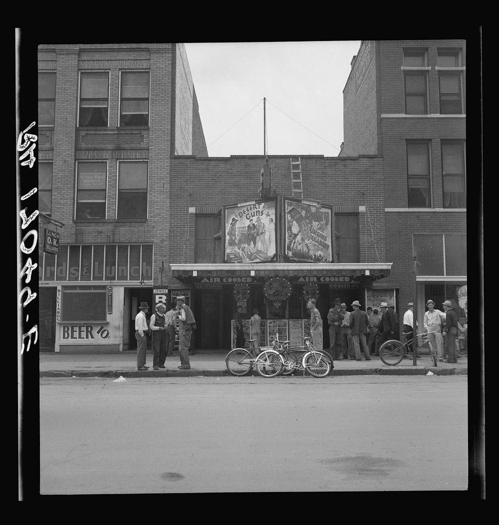 Idle men attend the morning movies. There are three such movies in one block. Oklahoma City, Oklahoma. Sourced from the…