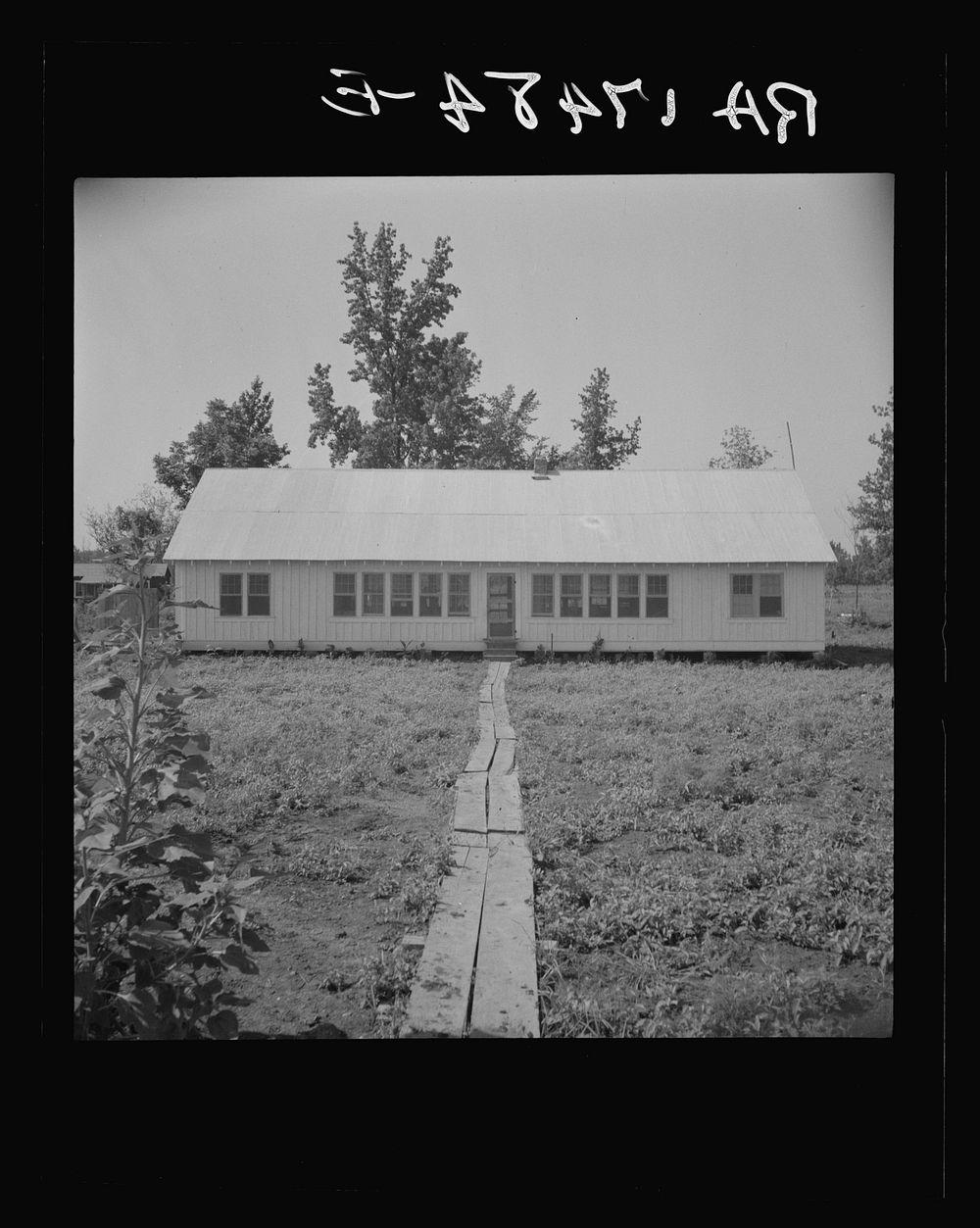 Newly erected community house at the Delta cooperative farm. Hillhouse, Mississippi. This building houses the library…