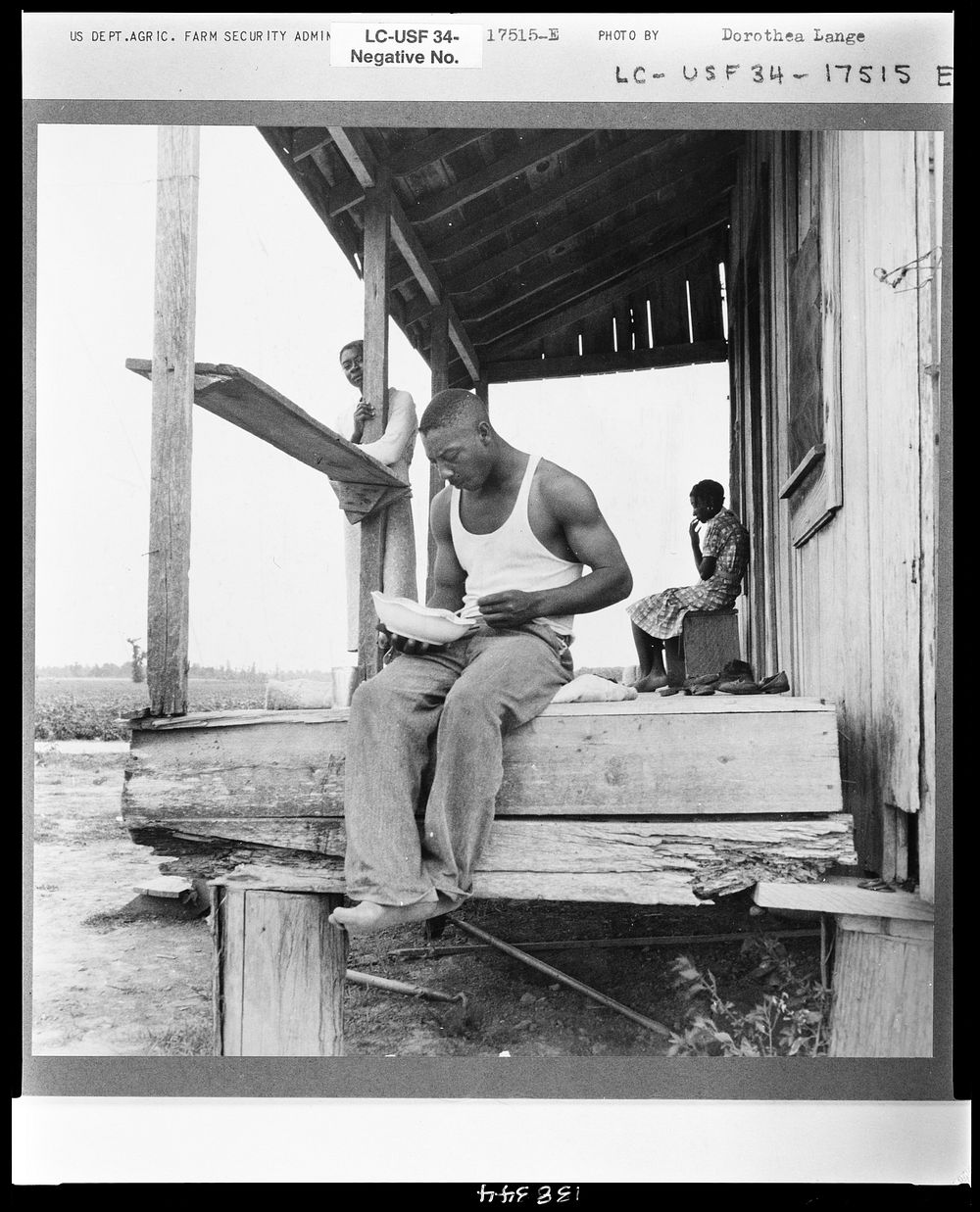 Sharecropper eating near Clarksdale, Mississippi by Dorothea Lange